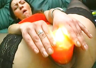Burning candle fucks her pussy