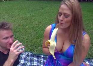 Curvy milf Holly is dangerously sexy in her blue summer dress. her suit cant hide her big juicy tits. She eats banana sexy in front of MILF Hunter and then flashes her hairless pussy. Watch her turn him on outdoors